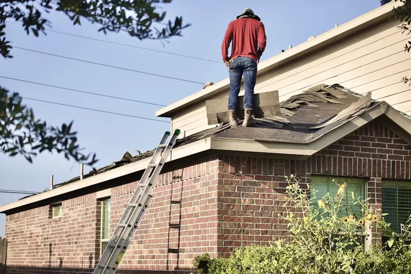 Professional roofer working on a residential roof in Campville